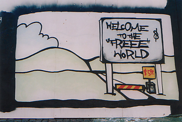Graffiti tekstillä "Welcome to the Free World", kuvassa tietullilla peritään dollareita